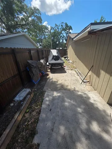 a view of backyard with outdoor seating and trees