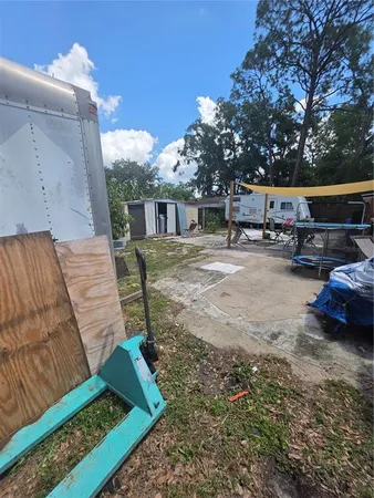 a view of a house with a yard and sitting area