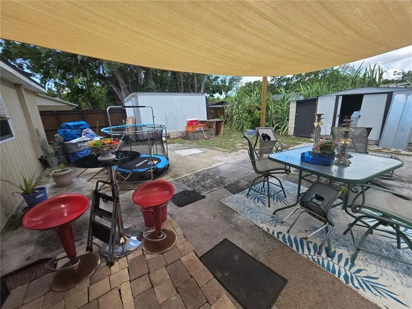 a view of a chairs and table in backyard