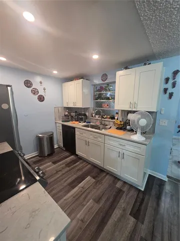 a kitchen with a stove a sink and a refrigerator