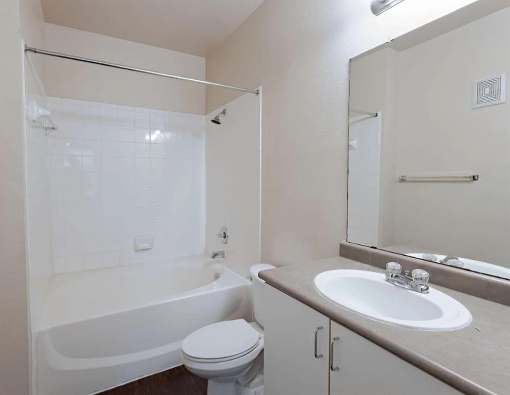 10505 I-35 Frontage Road South, Unit 1718 Austin, TX 78747 - Photo 20 of 21 a bathroom with a sink toilet vanity and shower