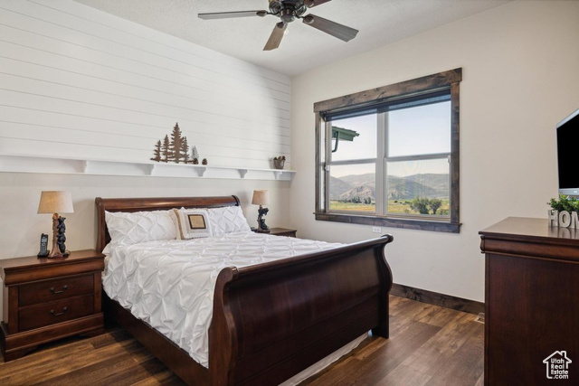 6117 North Rocky Ridge Road Peoa, UT 84061 - Photo 51 of 83 Bedroom with ceiling fan and dark hardwood / wood-style flooring