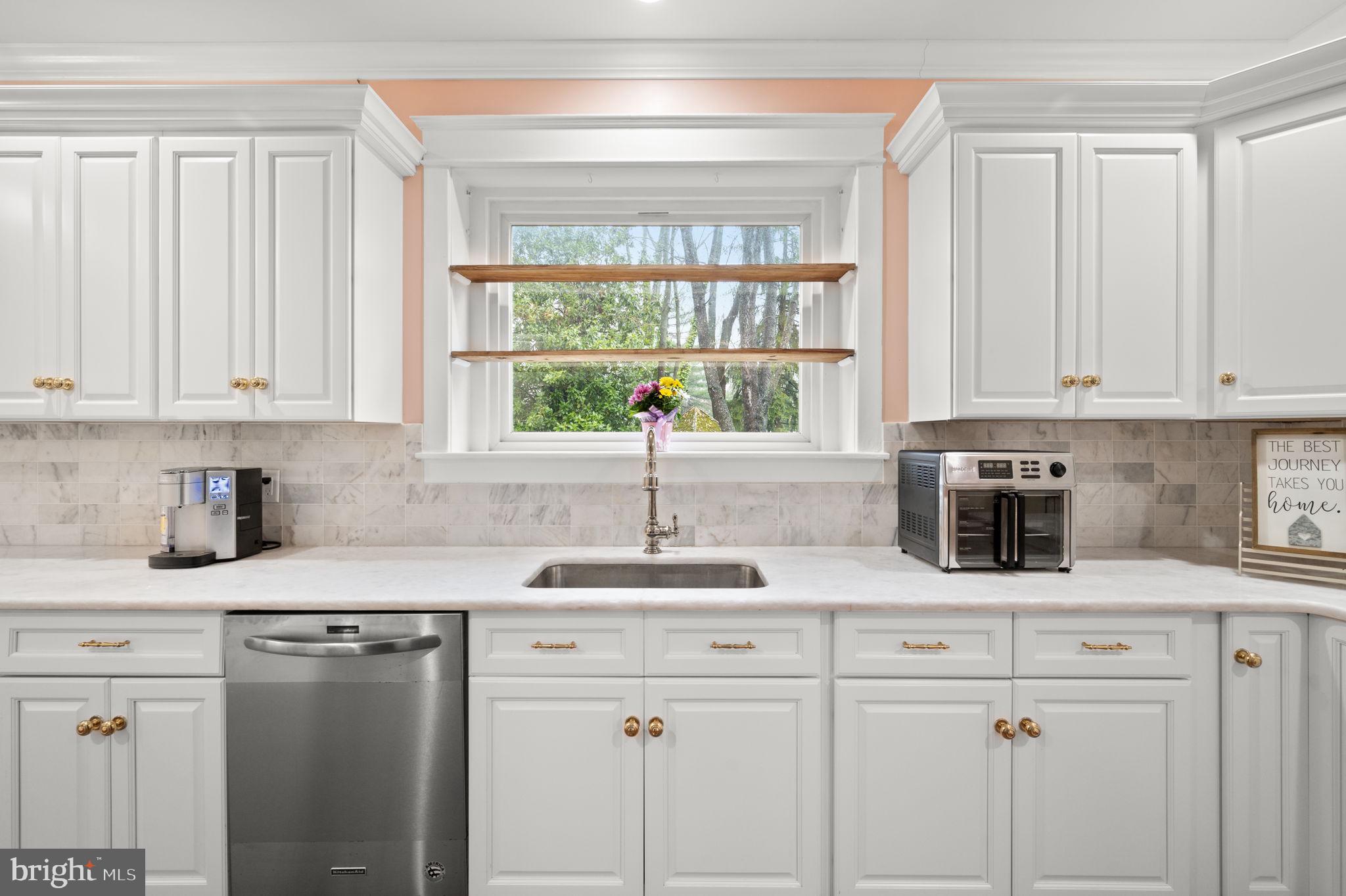 332 South Providence Road Wallingford, PA 19086 - Photo 17 of 69 a kitchen with stainless steel appliances granite countertop white cabinets a sink and a window