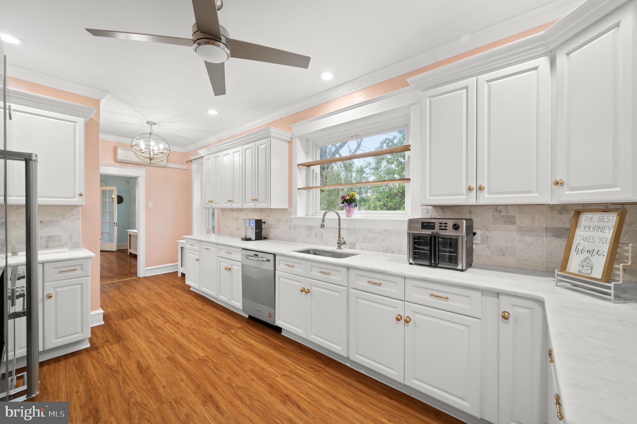 332 South Providence Road Wallingford, PA 19086 - Photo 18 of 69 a kitchen with white cabinets and white appliances