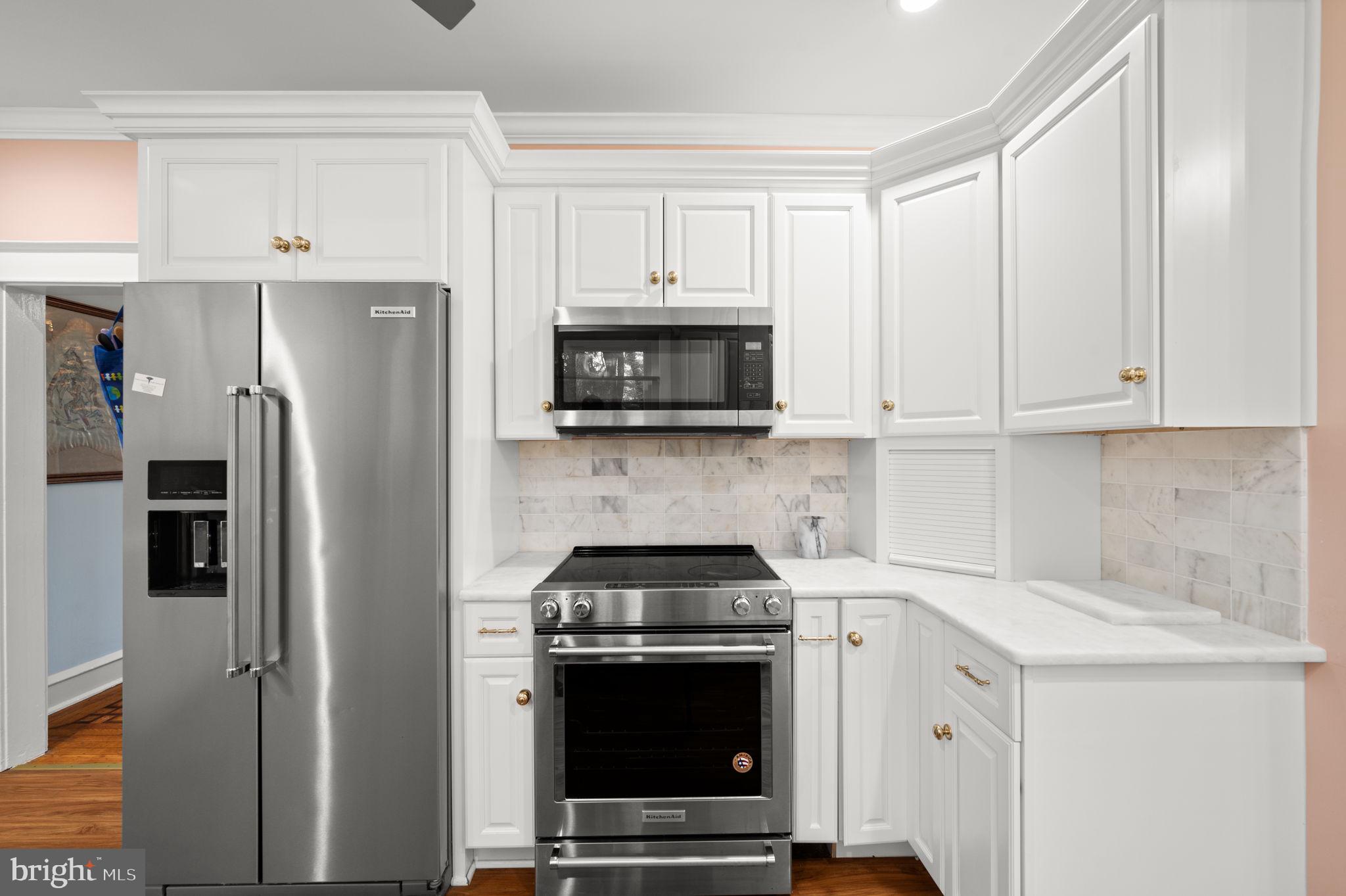 332 South Providence Road Wallingford, PA 19086 - Photo 20 of 69 a kitchen with stainless steel appliances a stove a microwave and a refrigerator
