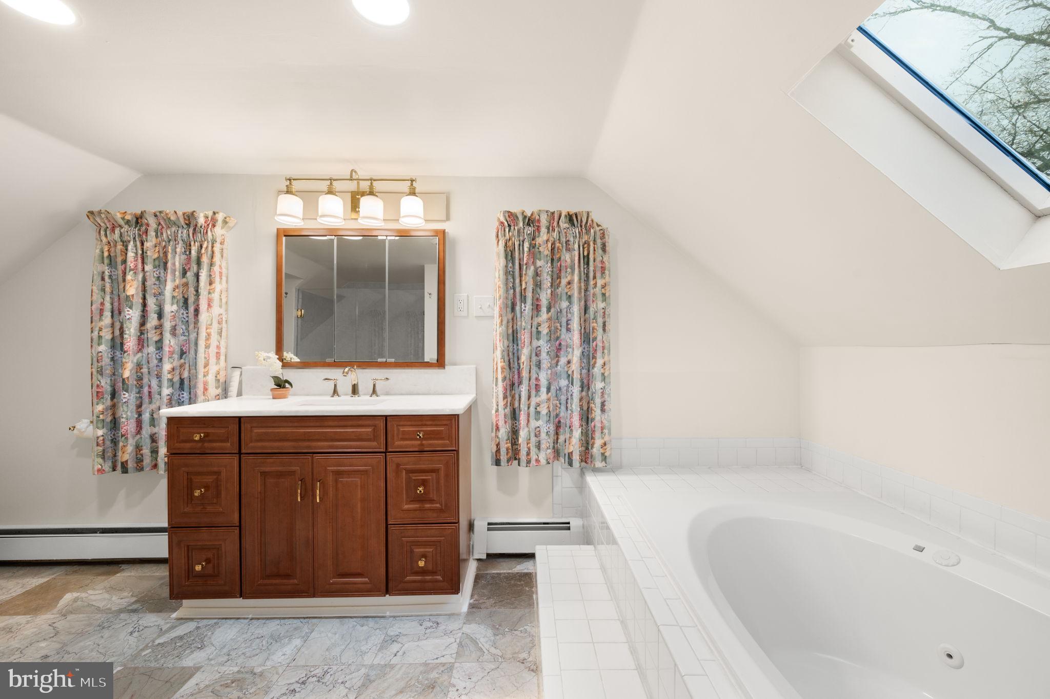 332 South Providence Road Wallingford, PA 19086 - Photo 37 of 69 a spacious bathroom with a tub sink and mirror