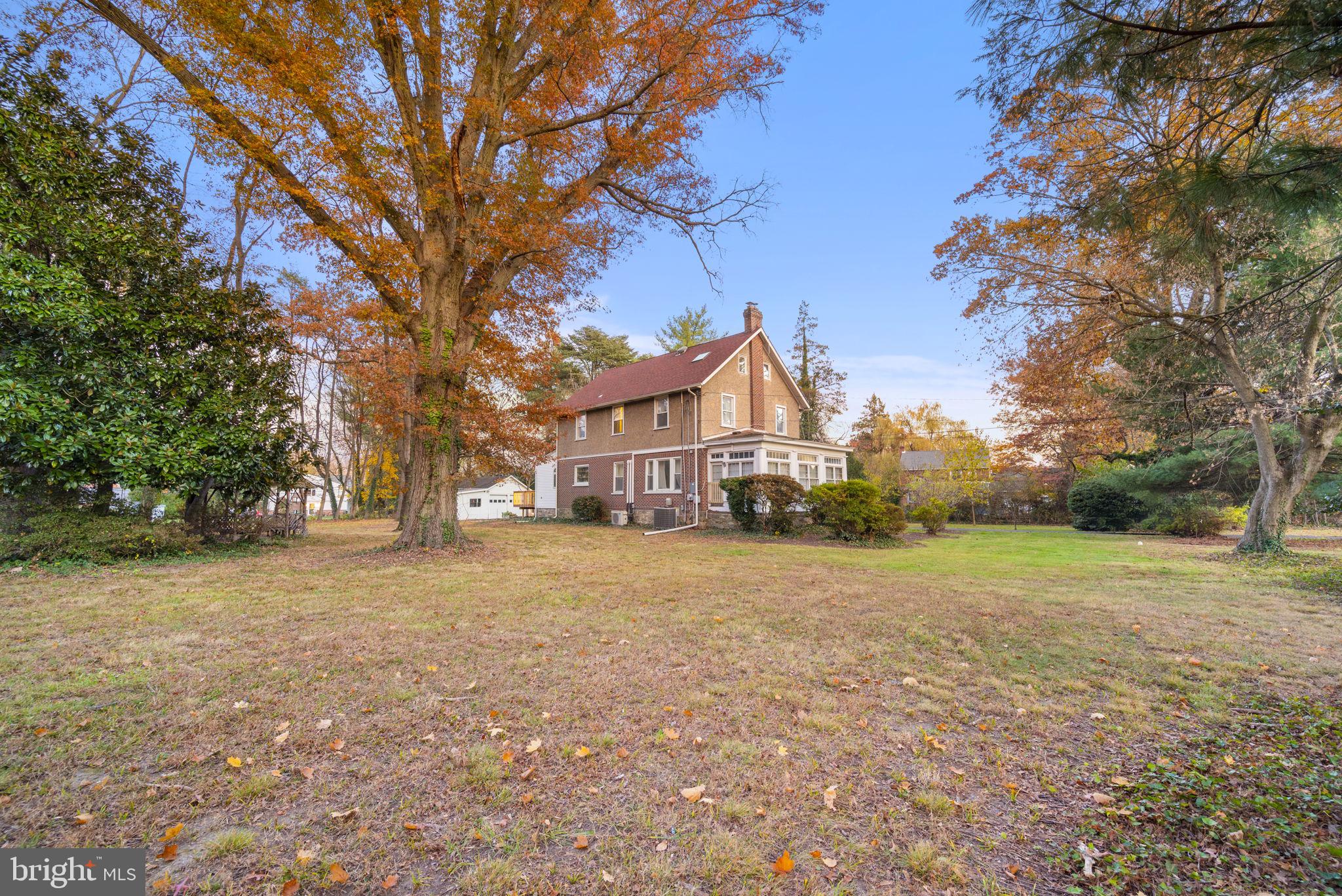 332 South Providence Road Wallingford, PA 19086 - Photo 56 of 69 a front view of a house with a yard and trees
