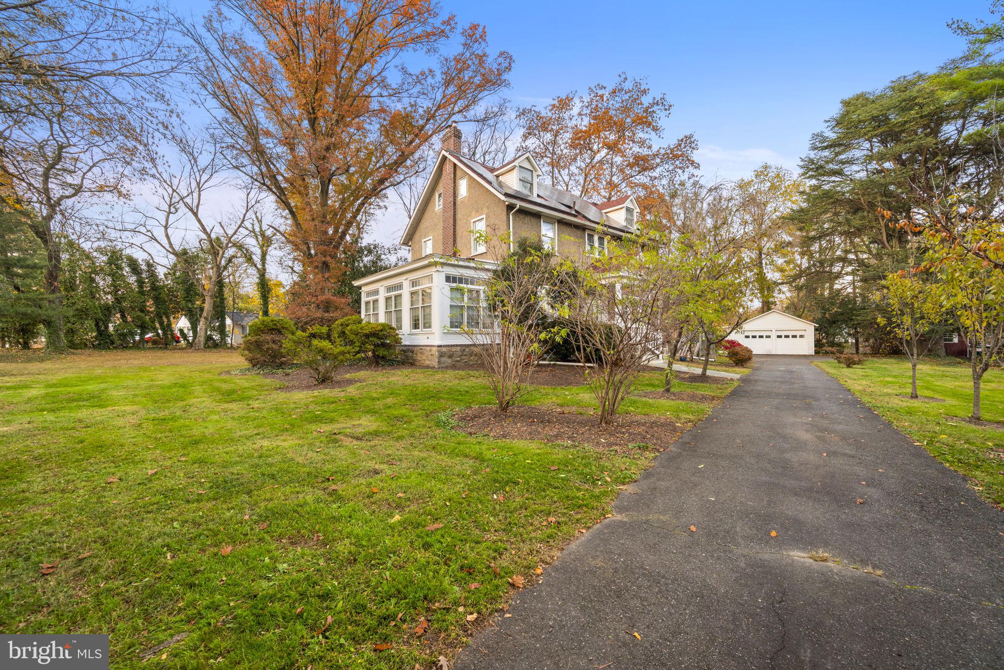 332 South Providence Road Wallingford, PA 19086 - Photo 6 of 69 a view of a house with a big yard and large trees