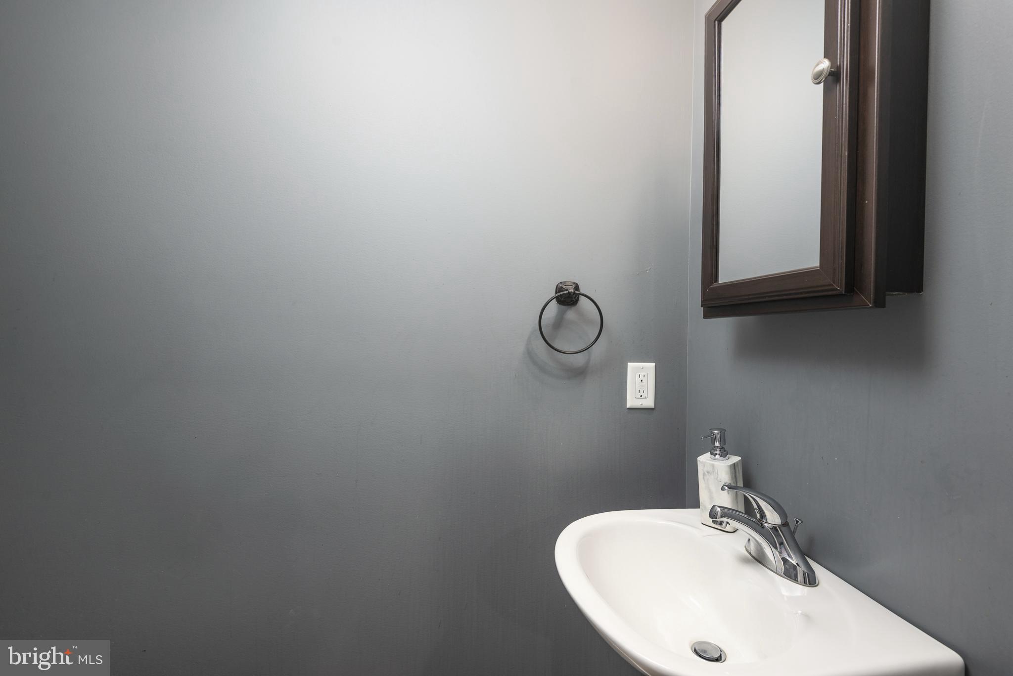 515 Franklin Street Denton, MD 21629 - Photo 12 of 21 a bathroom with a sink and mirror