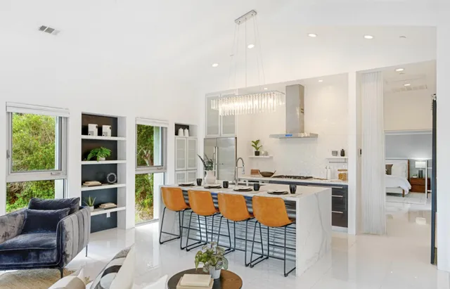 a kitchen with stainless steel appliances a stove a sink and cabinets