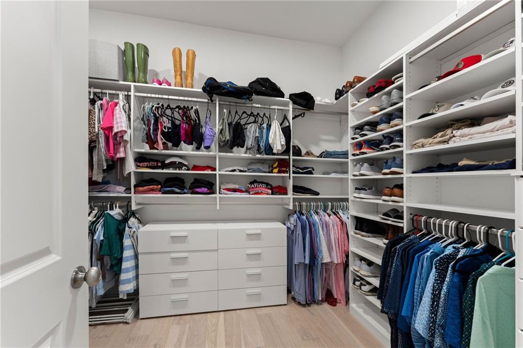 7170 Lullwater Road Cumming, GA 30040 - Photo 41 of 86 a view of walk in closet with clothes and shoes