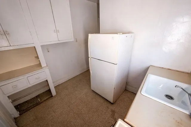 a view of room and refrigerator