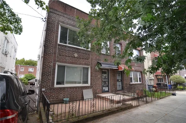 a front view of a house with parking area