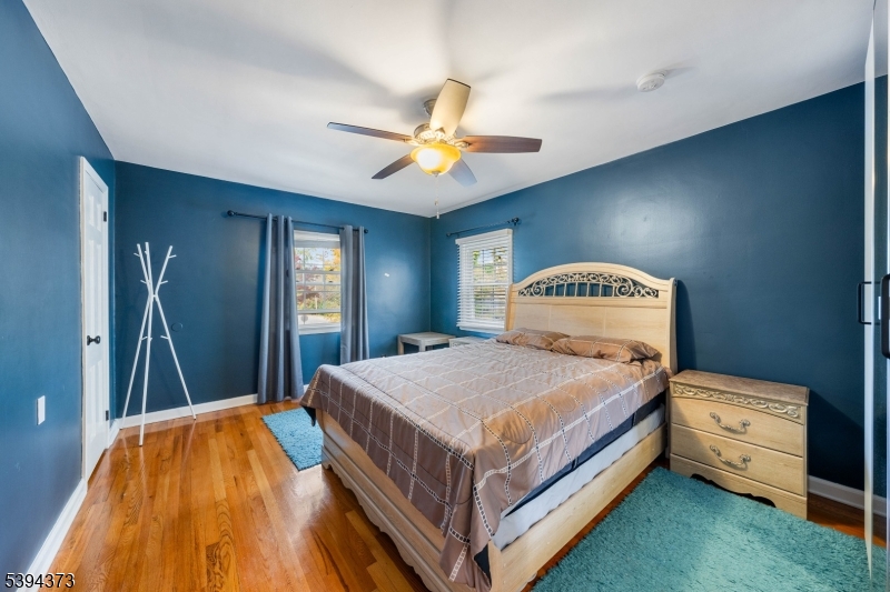 125 Meisel Avenue Springfield, NJ 07081 - Photo 13 of 32 a bedroom with a bed and a chandelier