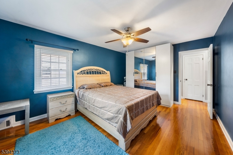 125 Meisel Avenue Springfield, NJ 07081 - Photo 14 of 32 a bedroom with a bed and a chandelier