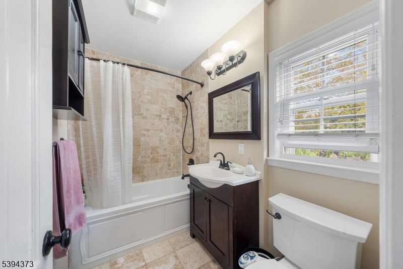 125 Meisel Avenue Springfield, NJ 07081 - Photo 15 of 32 a bathroom with a sink a toilet and shower