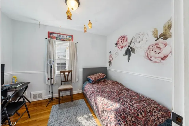 a bedroom with two beds and a chandelier