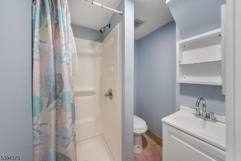 125 Meisel Avenue Springfield, NJ 07081 - Photo 22 of 32 a bathroom with a sink a toilet and shower