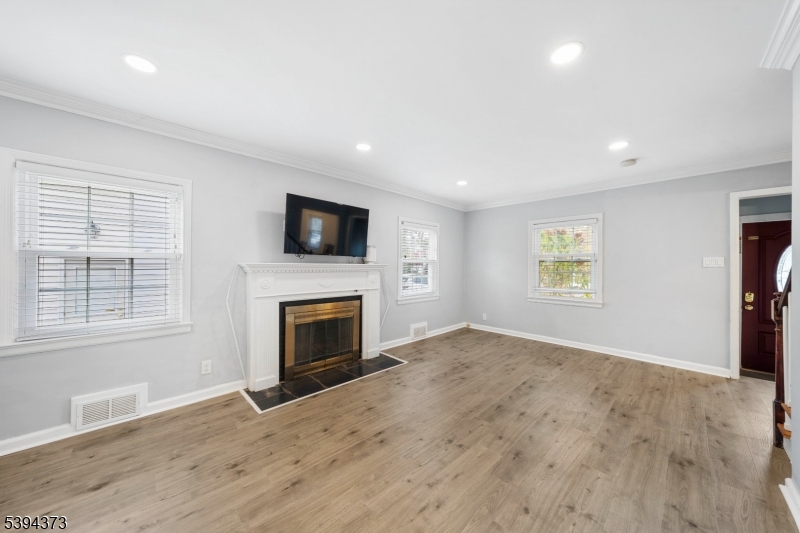 125 Meisel Avenue Springfield, NJ 07081 - Photo 6 of 32 an empty room with windows and fireplace