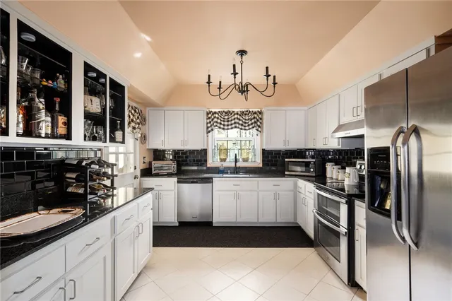 a kitchen with stainless steel appliances a refrigerator sink and cabinets
