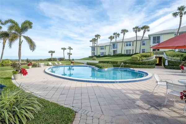 a view of swimming pool with outdoor seating