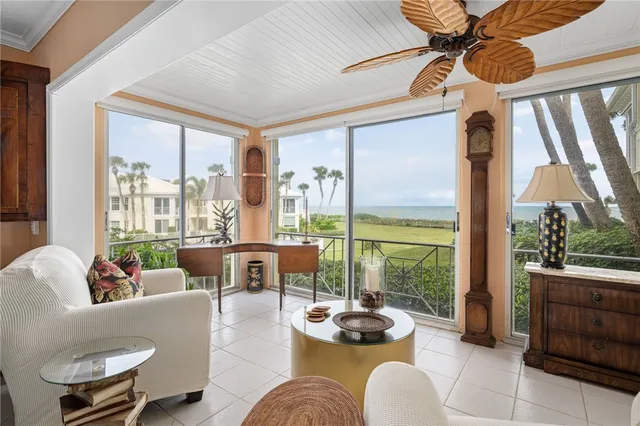 a living room with furniture and a floor to ceiling window
