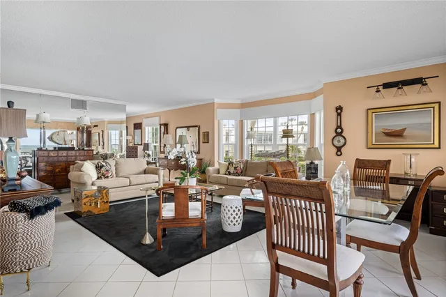a living room with furniture a fireplace and large windows