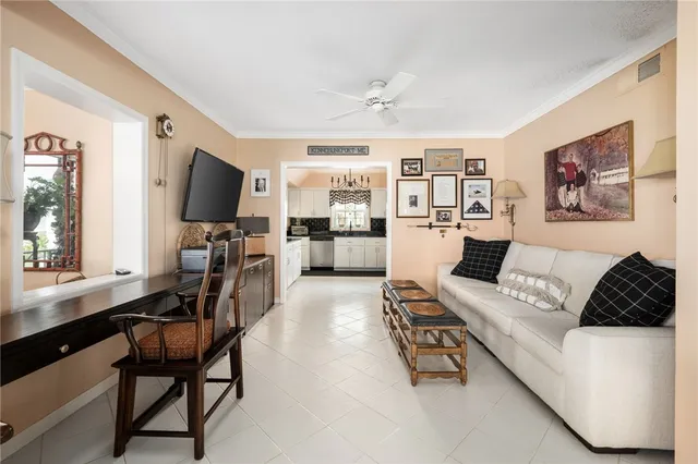 a living room with furniture a flat screen tv and a window