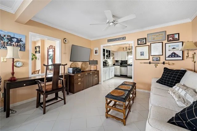 a living room with furniture and kitchen view