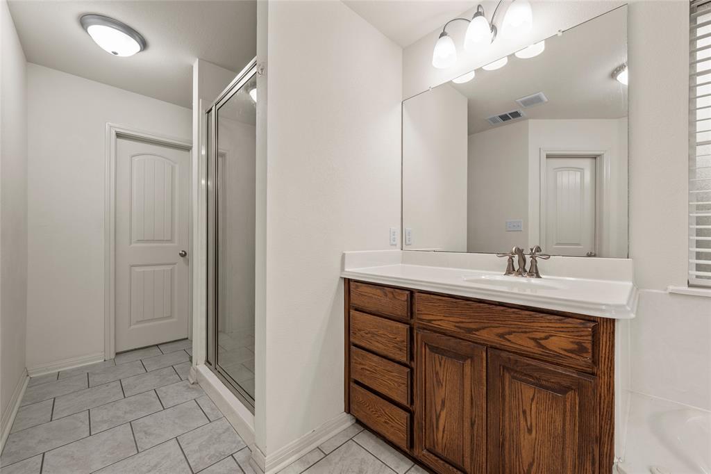 109 Ruby Circle Hewitt, TX 76643 - Photo 10 of 14 a bathroom with a double vanity sink and a mirror