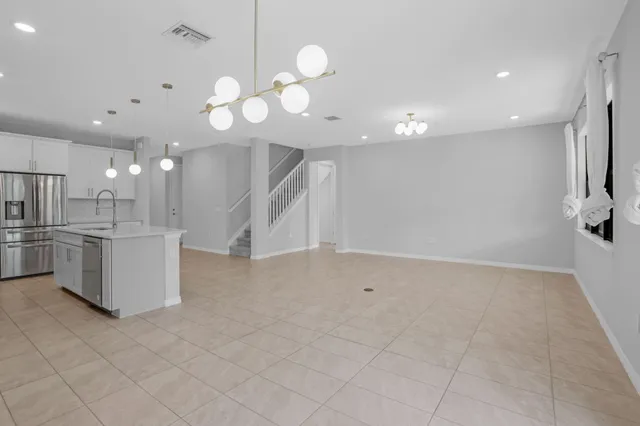a view of a kitchen with a sink and chandelier