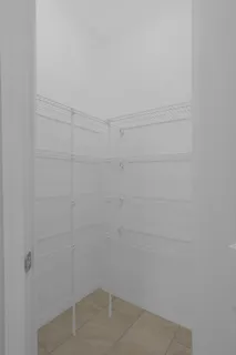 a kitchen with granite countertop white cabinets and black stainless steel appliances