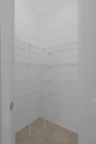 a kitchen with granite countertop white cabinets and black stainless steel appliances