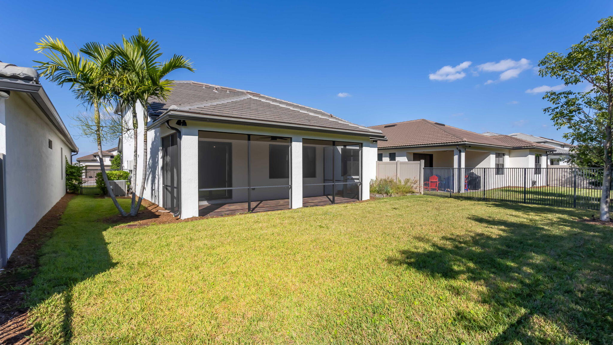 8296 Vaulting Drive Lake Worth, FL 33467 - Photo 22 of 62 a front view of a house with a garden