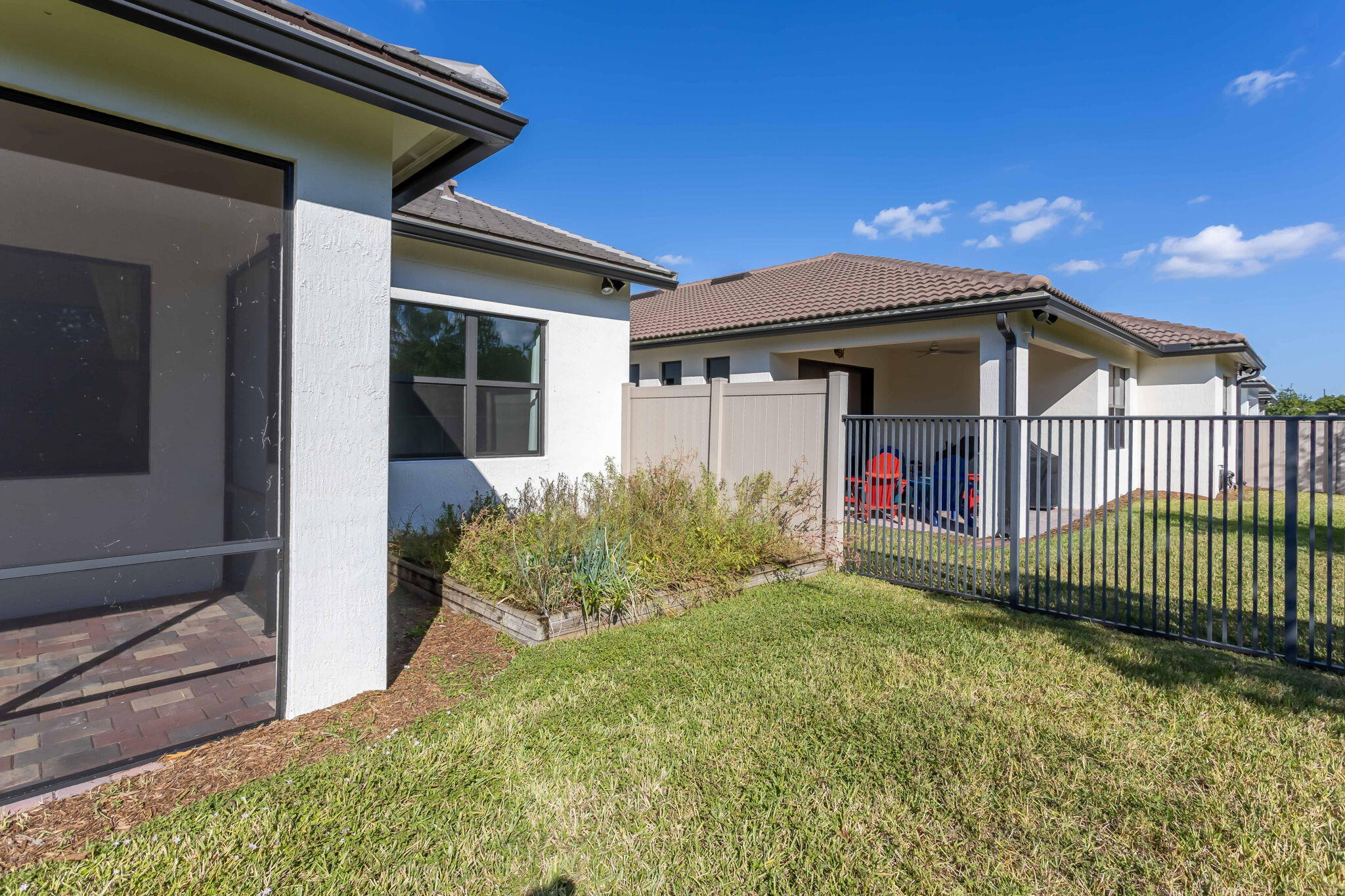 8296 Vaulting Drive Lake Worth, FL 33467 - Photo 24 of 62 a front view of a house with garden