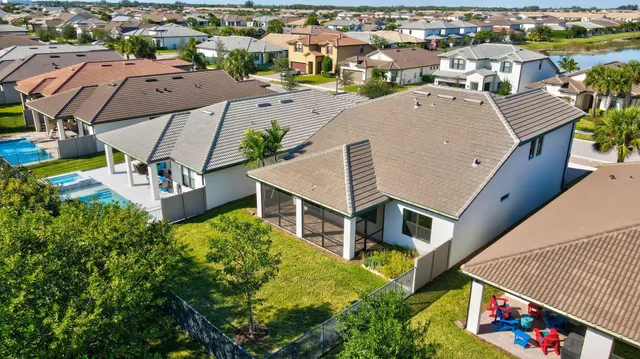 an aerial view of a house with swimming pool and ocean view