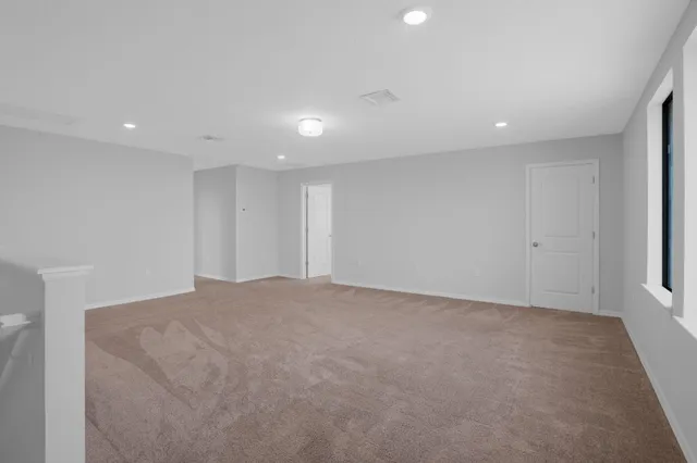 a view of an empty room with windows