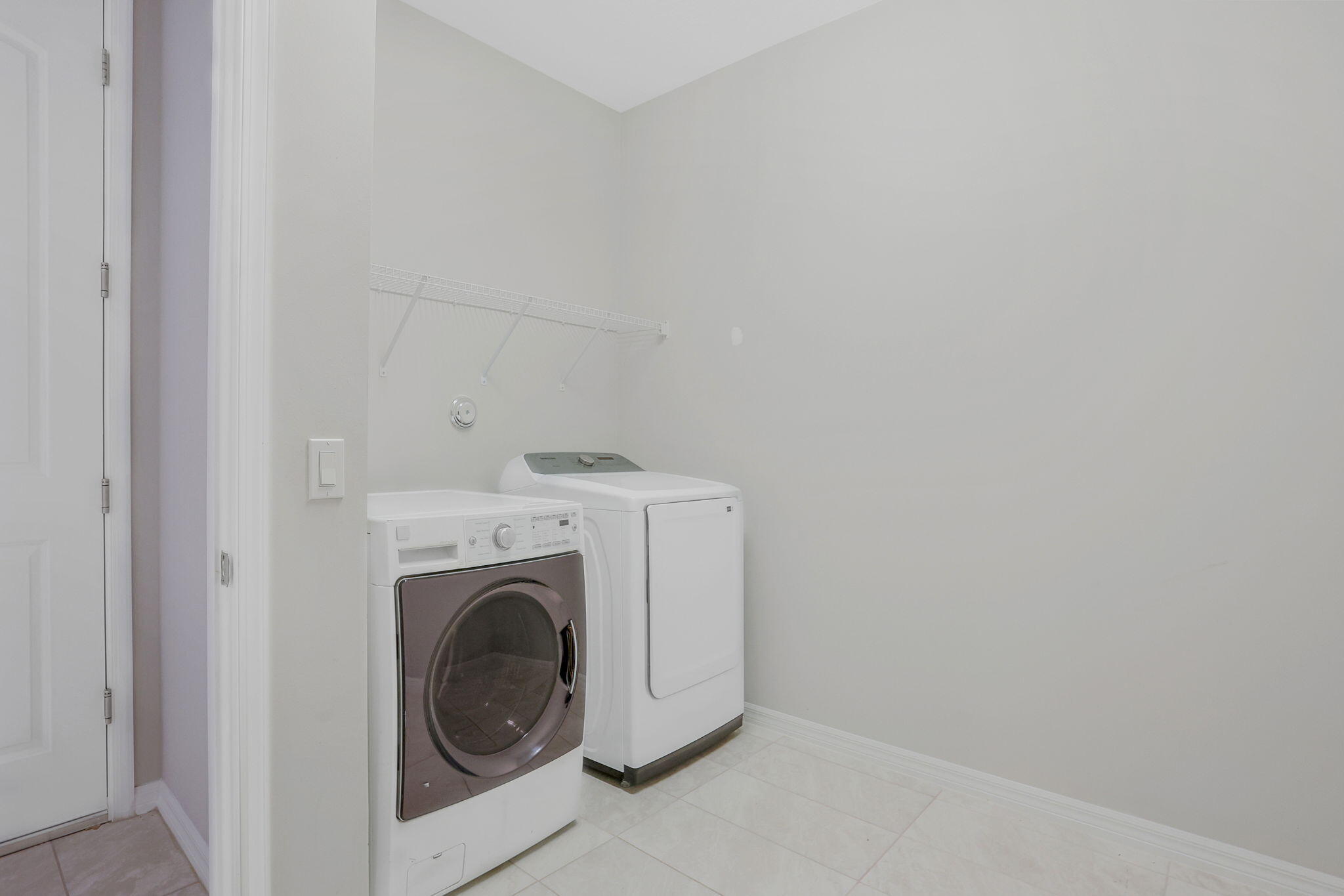 8296 Vaulting Drive Lake Worth, FL 33467 - Photo 47 of 62 a utility room with dryer and washer