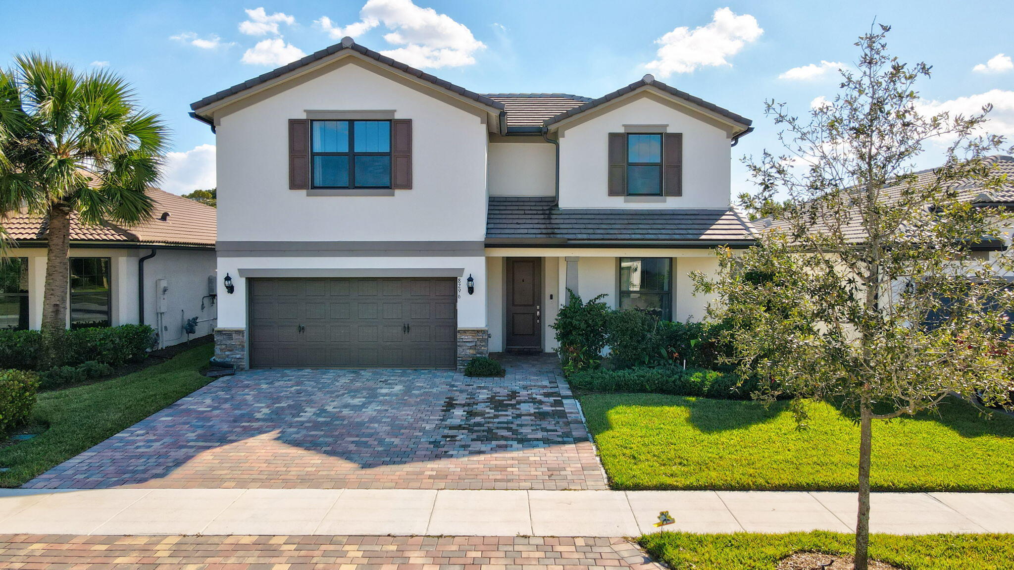 8296 Vaulting Drive Lake Worth, FL 33467 - Photo 5 of 62 a front view of a house with a yard and garage