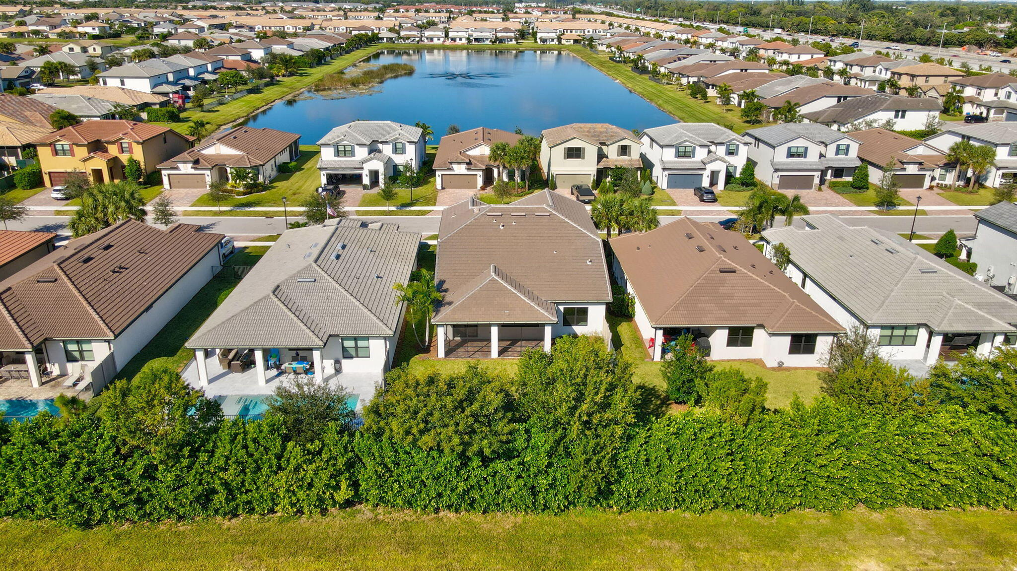 8296 Vaulting Drive Lake Worth, FL 33467 - Photo 60 of 62 an aerial view of multiple houses with yard