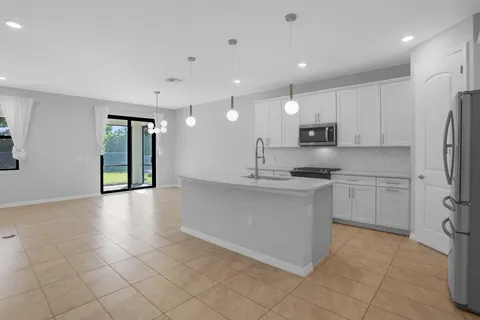 a kitchen with stainless steel appliances granite countertop a refrigerator sink and cabinets