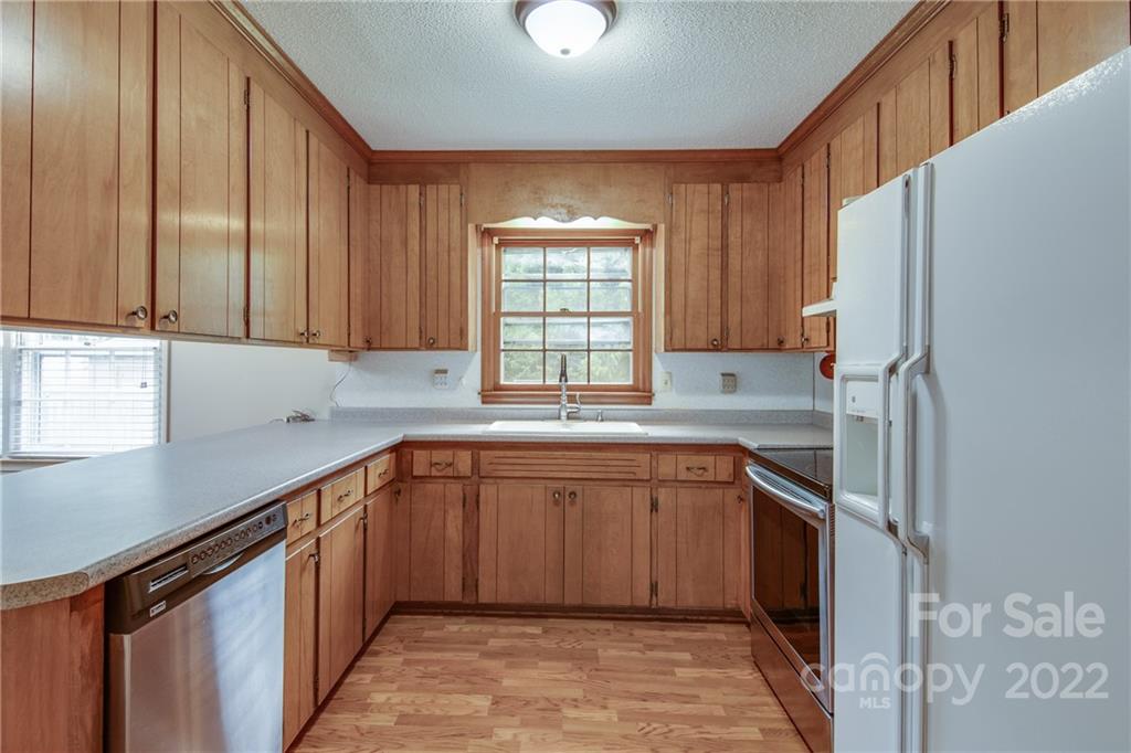 5338 Mt Gallant Road Rock Hill, SC 29732 - Photo 12 of 31 a kitchen with stainless steel appliances granite countertop a refrigerator sink and cabinets
