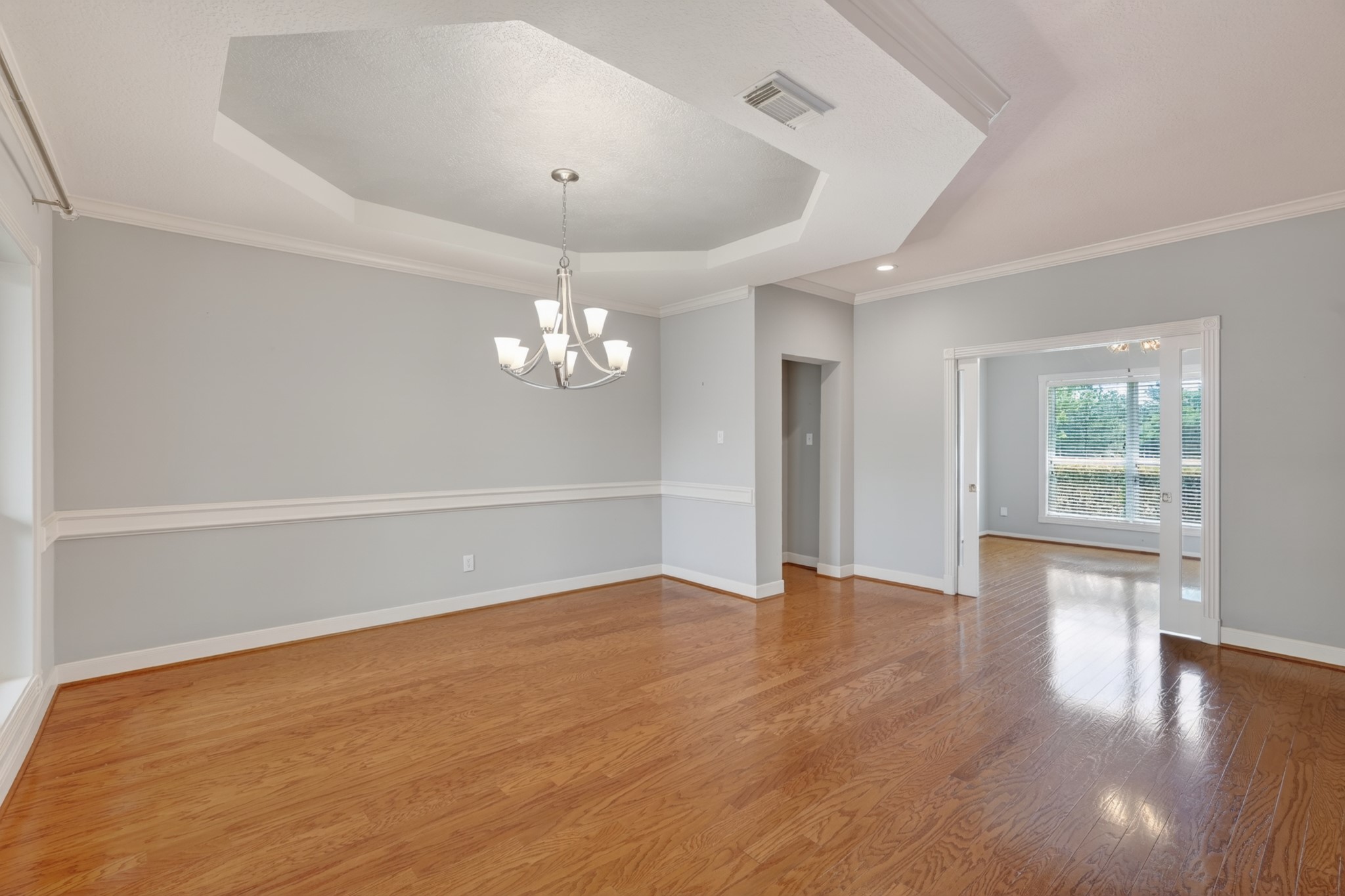 20714 Flora View Court Spring, TX 77379 - Photo 6 of 40 an empty room with wooden floor and windows