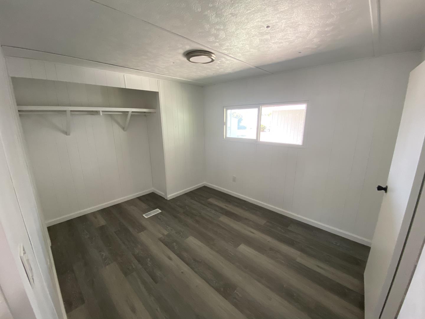 1220 Tasman Drive, Unit 87D Sunnyvale, CA 94089 - Photo 2 of 16 a view of an empty room with wooden floor and a window