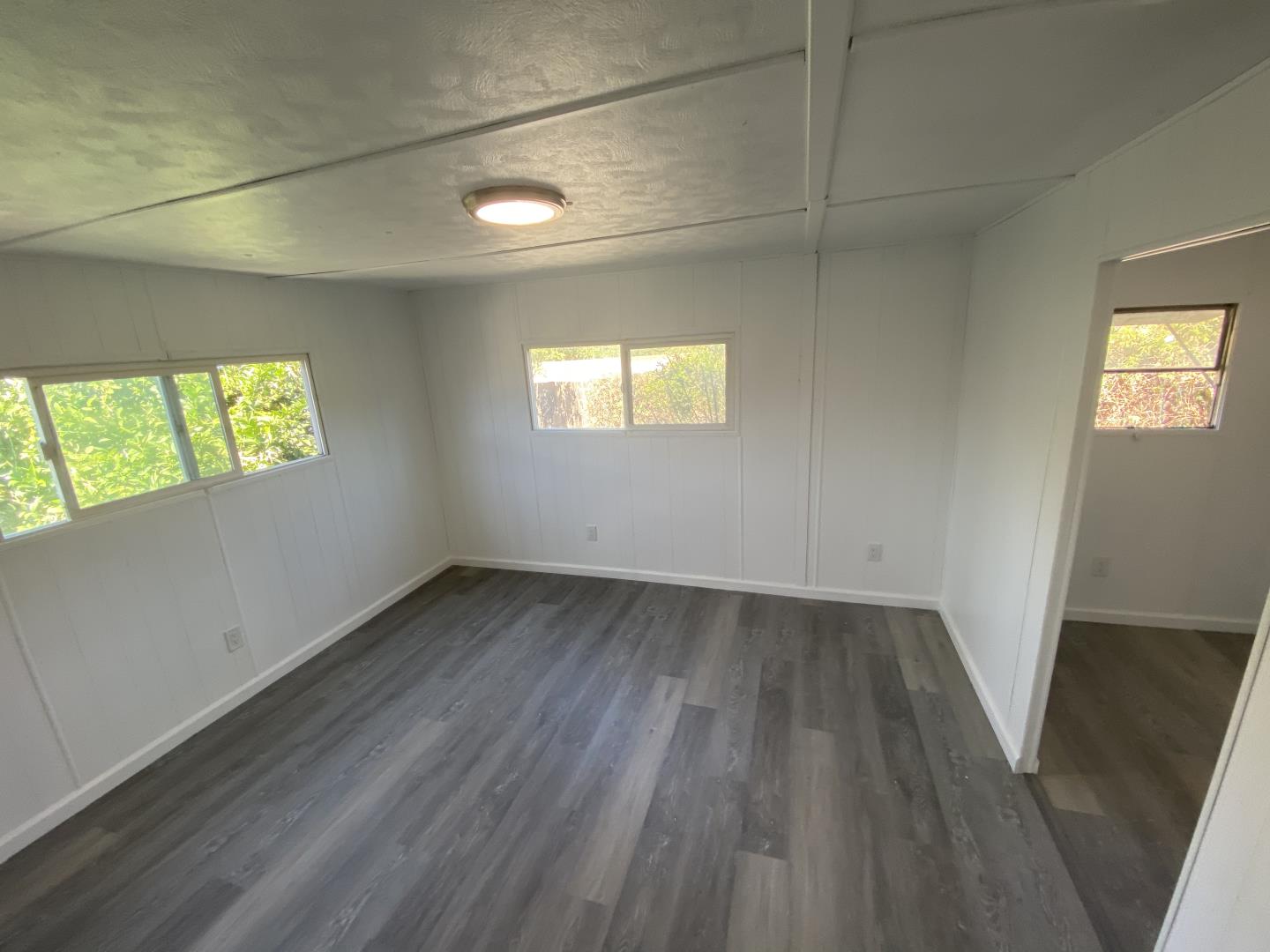 1220 Tasman Drive, Unit 87D Sunnyvale, CA 94089 - Photo 7 of 16 an empty room with wooden floor and windows