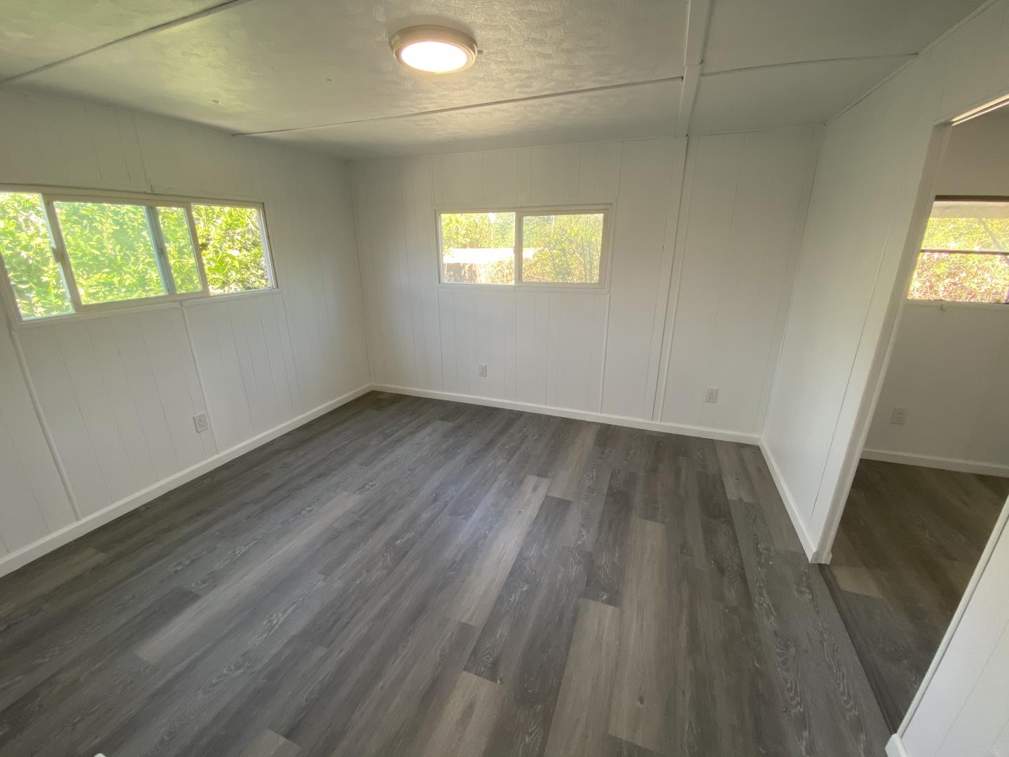 1220 Tasman Drive, Unit 87D Sunnyvale, CA 94089 - Photo 8 of 16 an empty room with wooden floor and windows