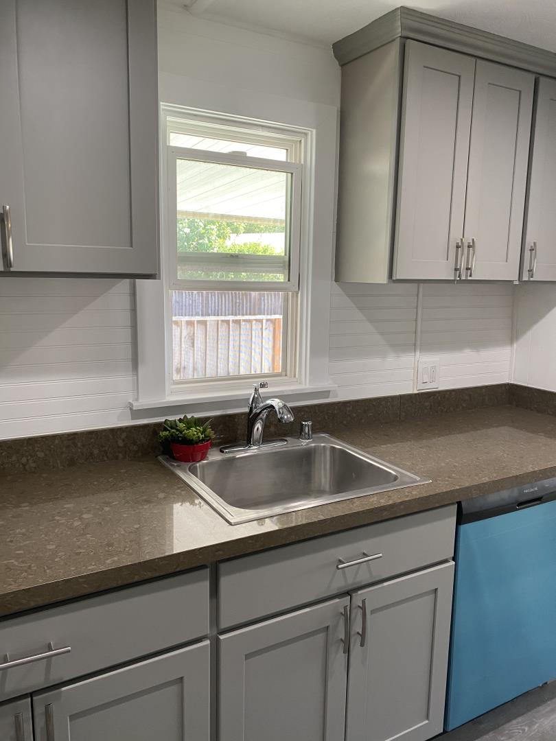 1220 Tasman Drive, Unit 87D Sunnyvale, CA 94089 - Photo 10 of 16 a kitchen with granite countertop a sink and a white cabinets