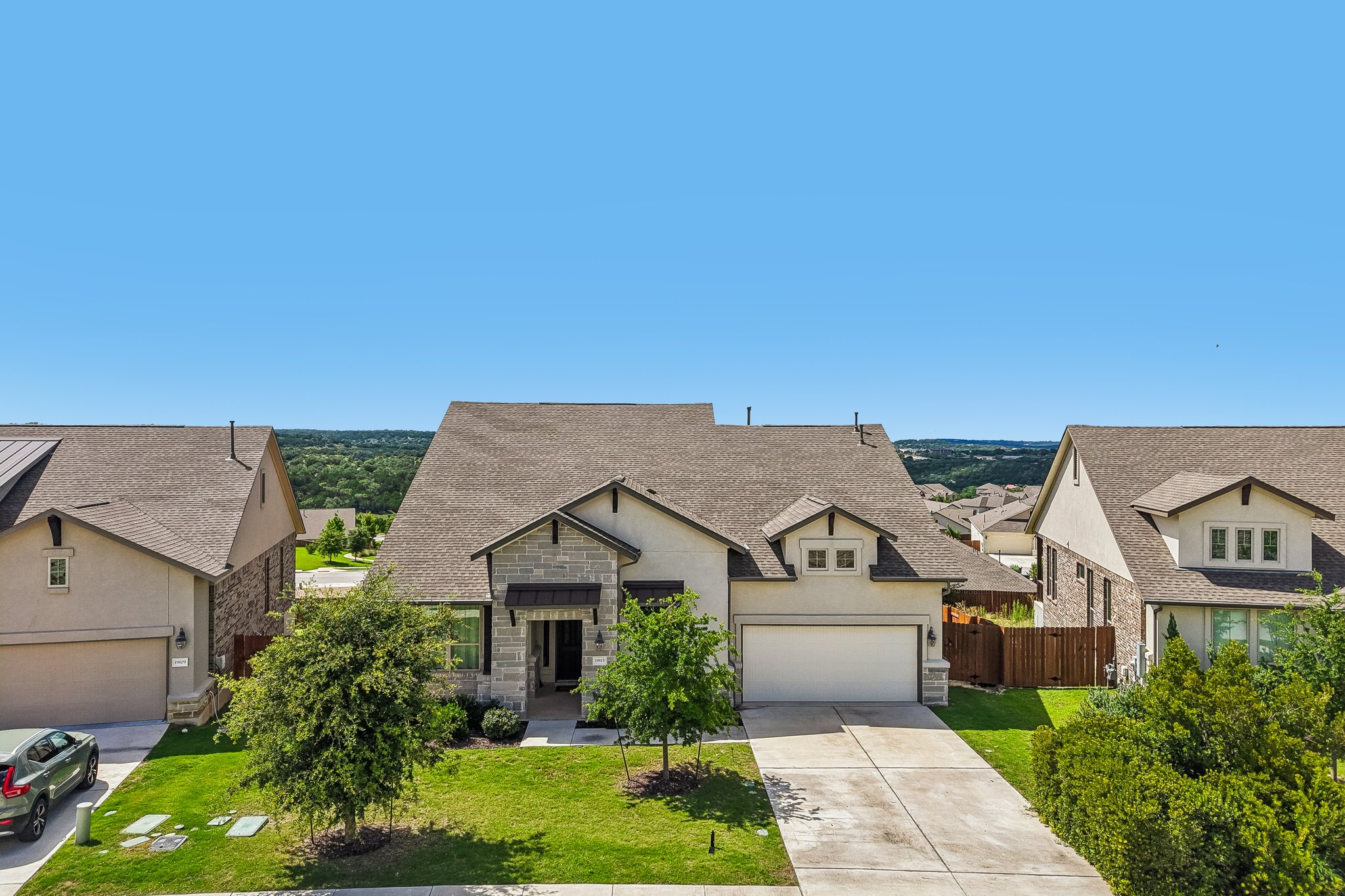 19113 Freeman Circle Austin, TX 78738 - Photo 29 of 37 An inviting facade with a two-car garage and manicured lawn welcomes residents.