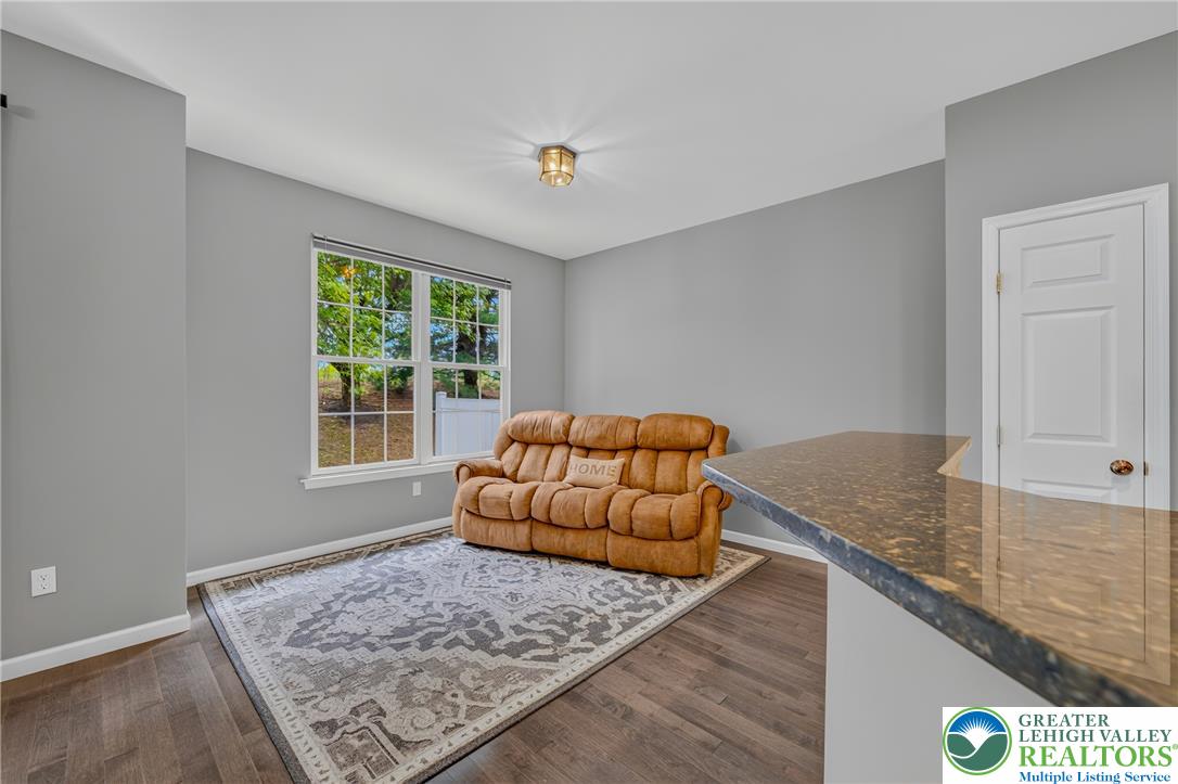 4236 Creek Road Allentown, PA 18104 - Photo 14 of 47 Rich hardwood flooring complements a granite bar top in this versatile living space.