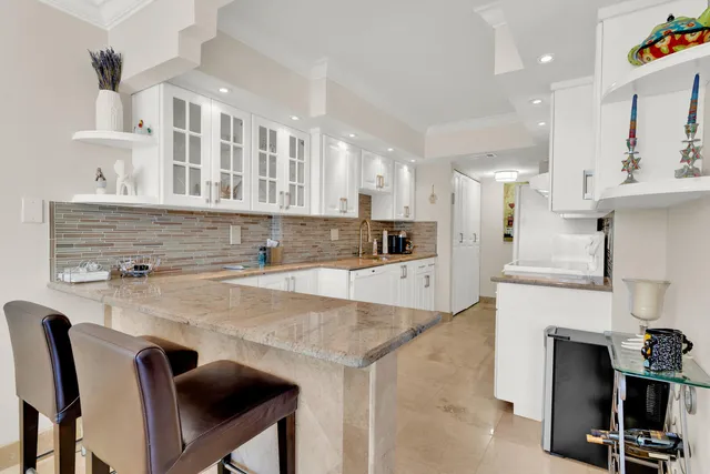 a view of kitchen with stainless steel appliances cabinets a counter top space and a sink